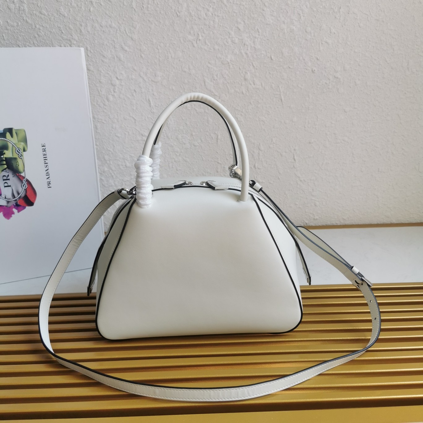 pra*a S*pernova small handbag in white leather