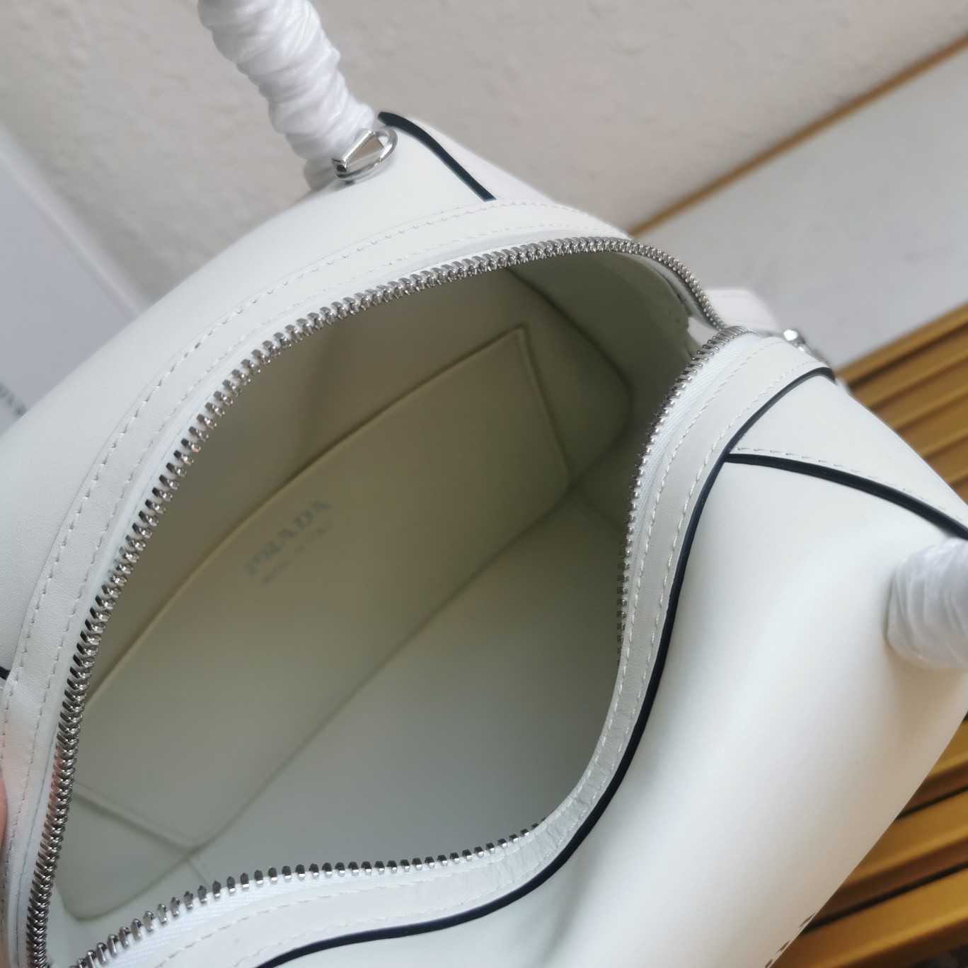 pra*a S*pernova small handbag in white leather