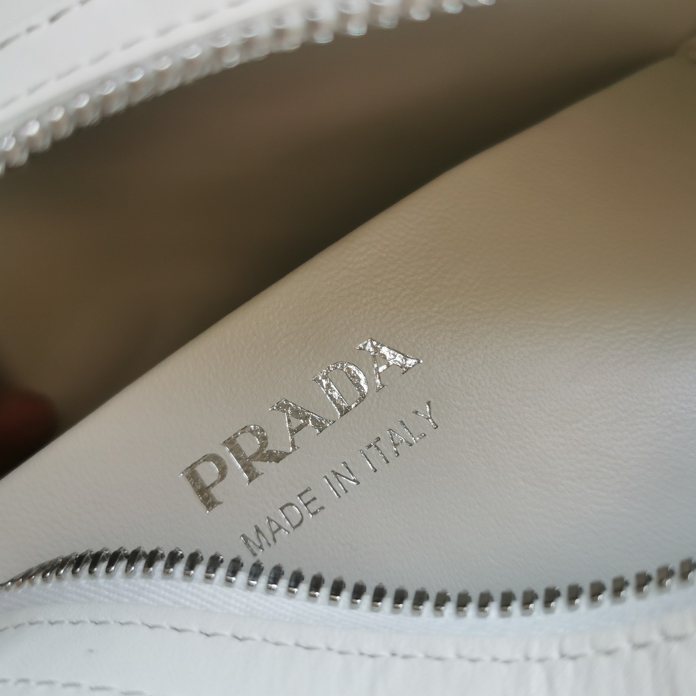 pra*a S*pernova small handbag in white leather