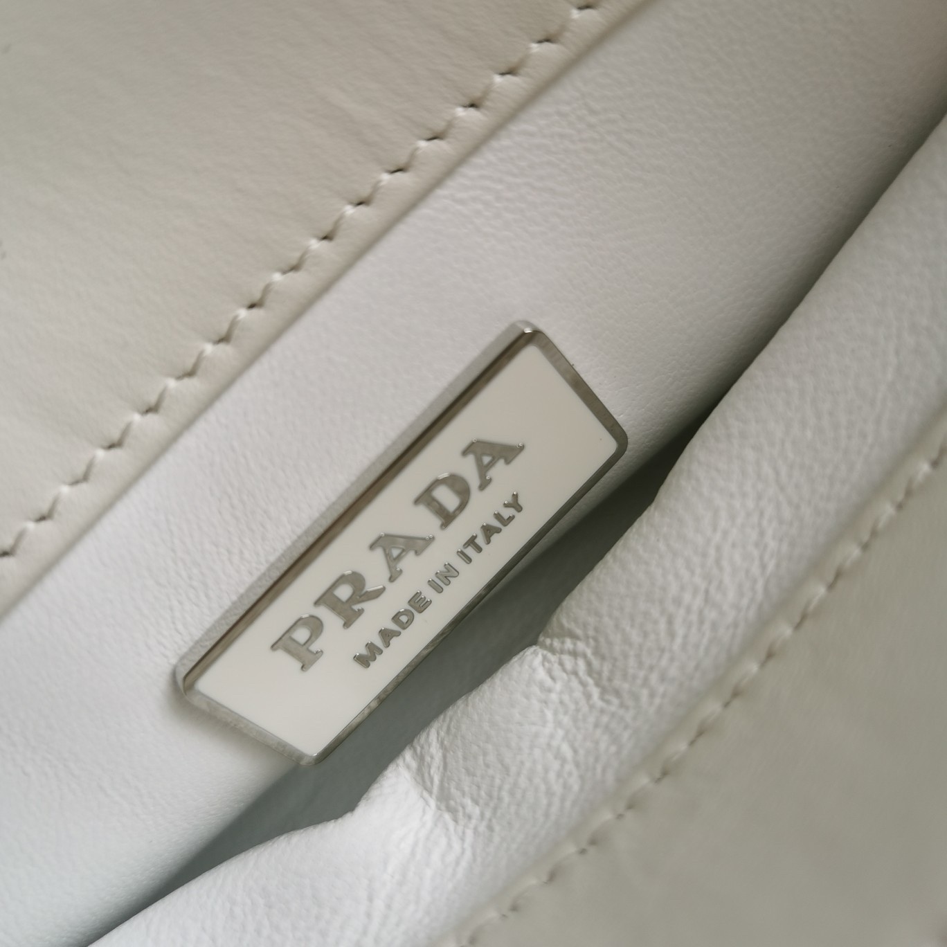 pra*a S*pernova small shoulder bag in white leather
