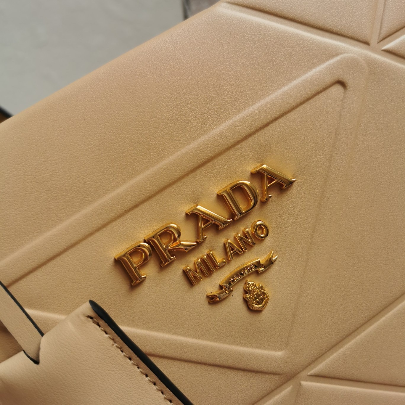 Pra*a symbole small bag with topstitching in beige leather