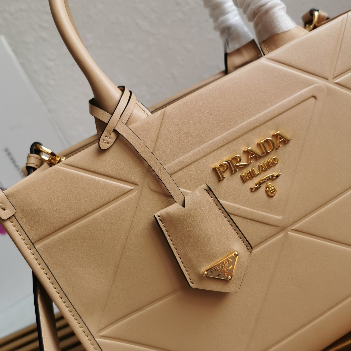Pra*a symbole small bag with topstitching in beige leather