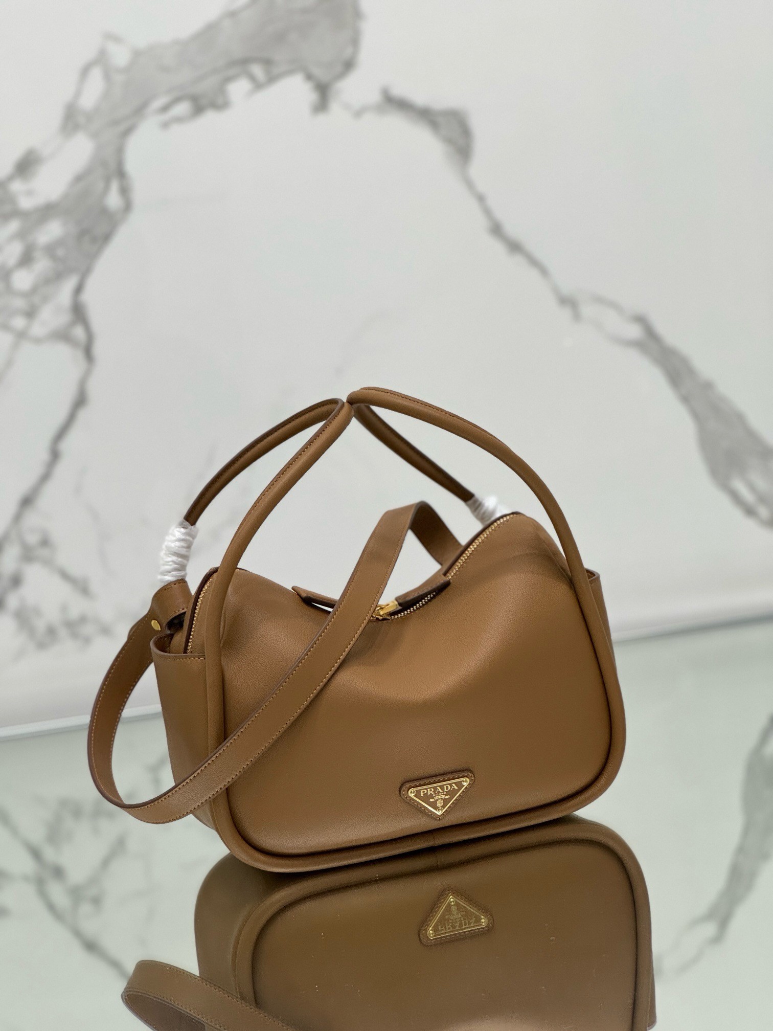 Pra*a top handle bag in caramel grained leather