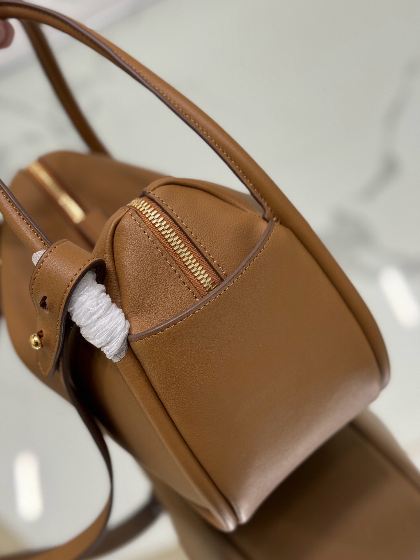 Pra*a top handle bag in caramel grained leather