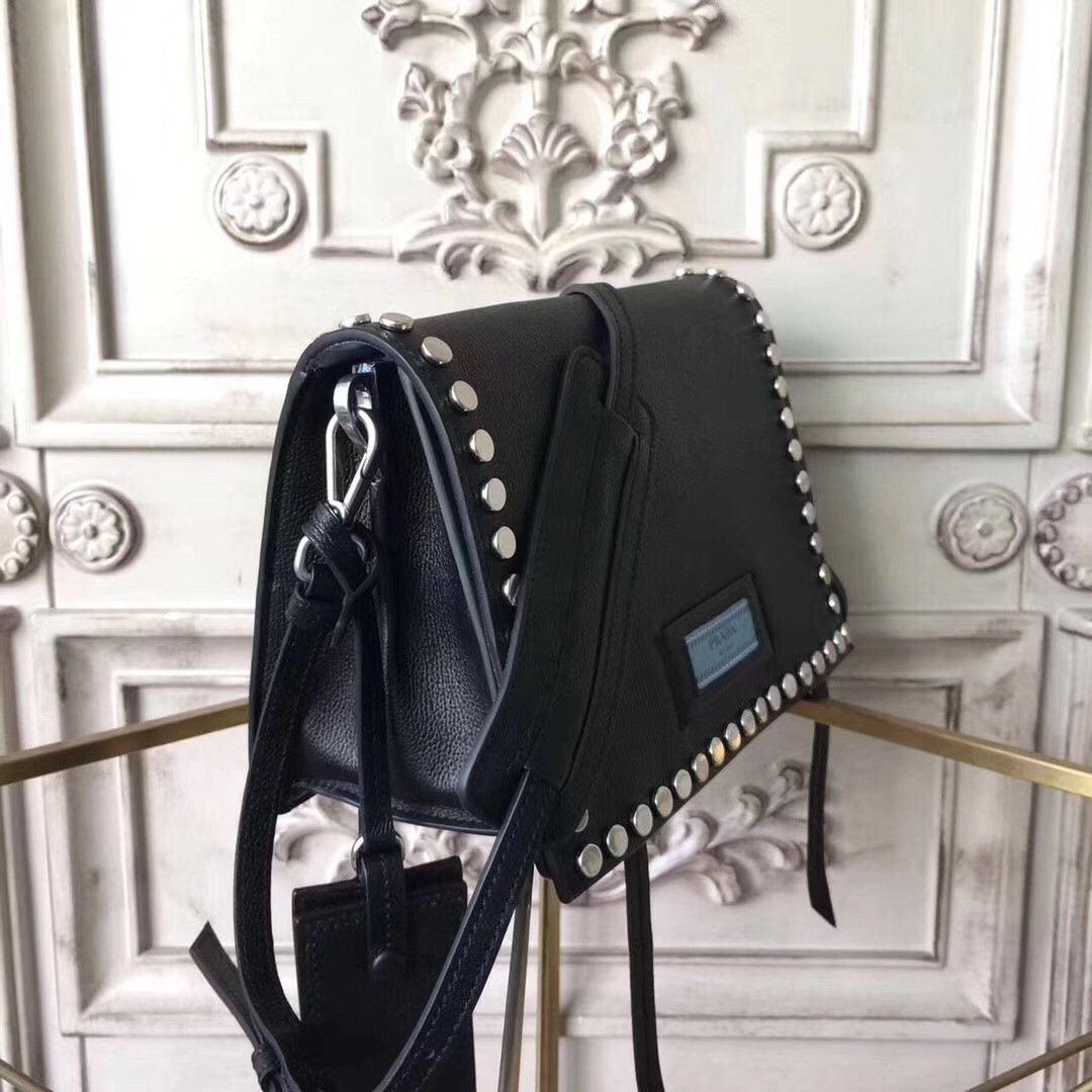 Pra*a etiquette bag in black calfskin with metal stud trim