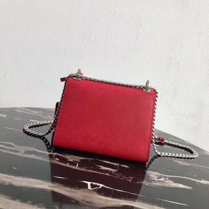 Pra*a red monochrome flap bag with metal appliques