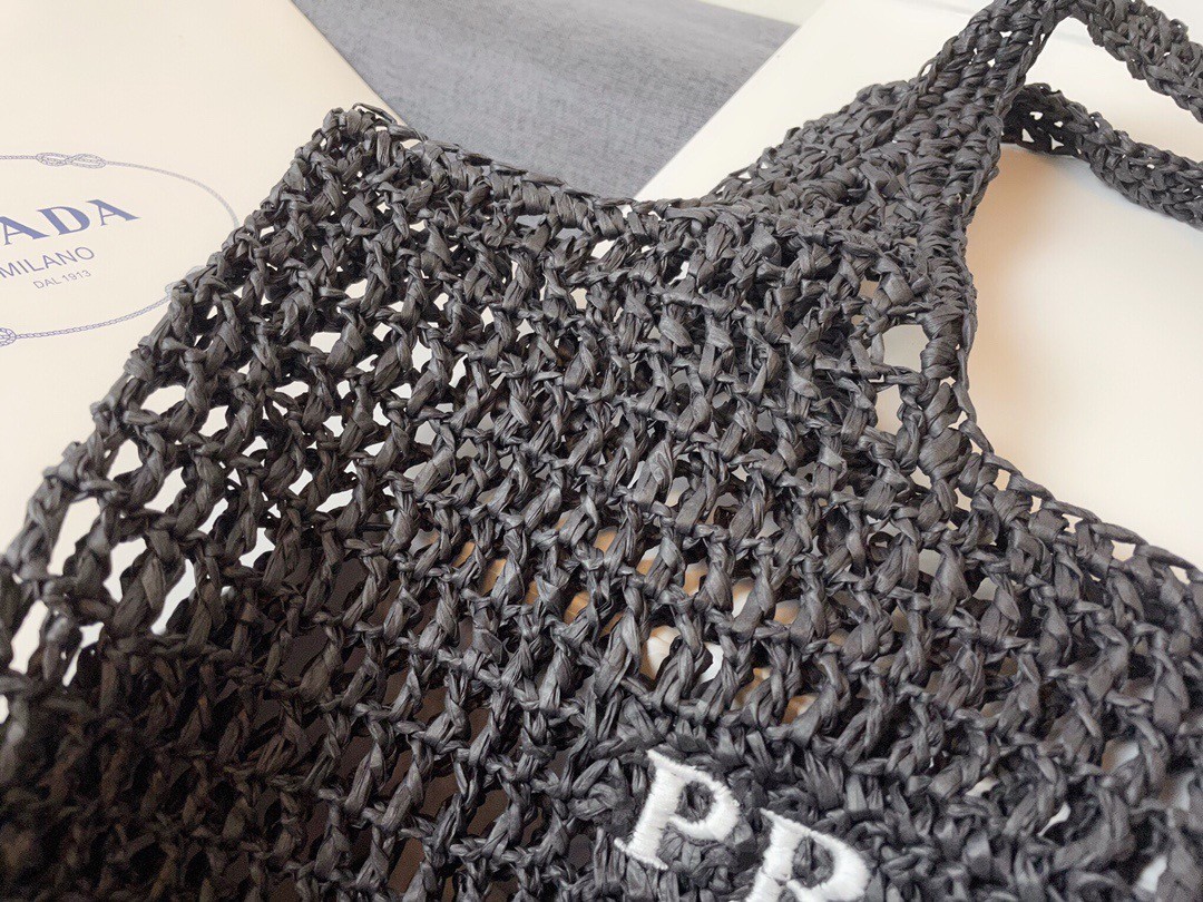 Pra*a large tote bag in black woven raffia