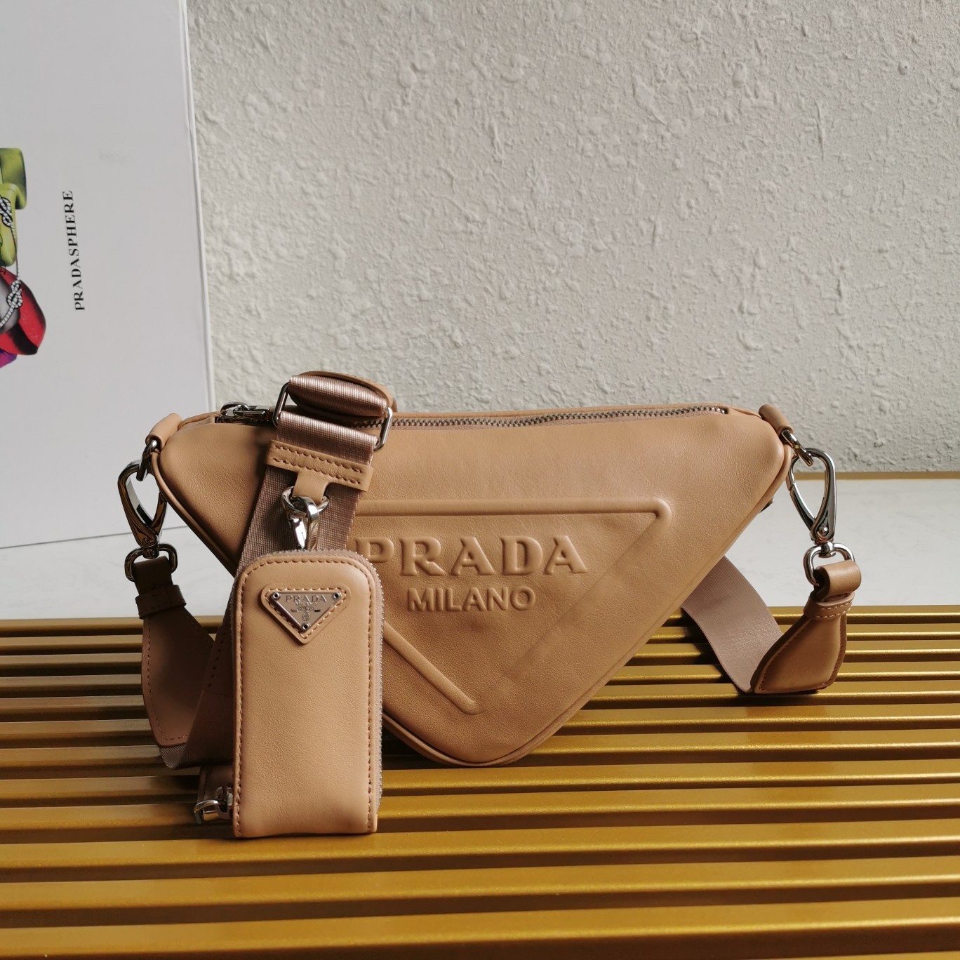 Pra*a triangle shoulder bag in beige leather