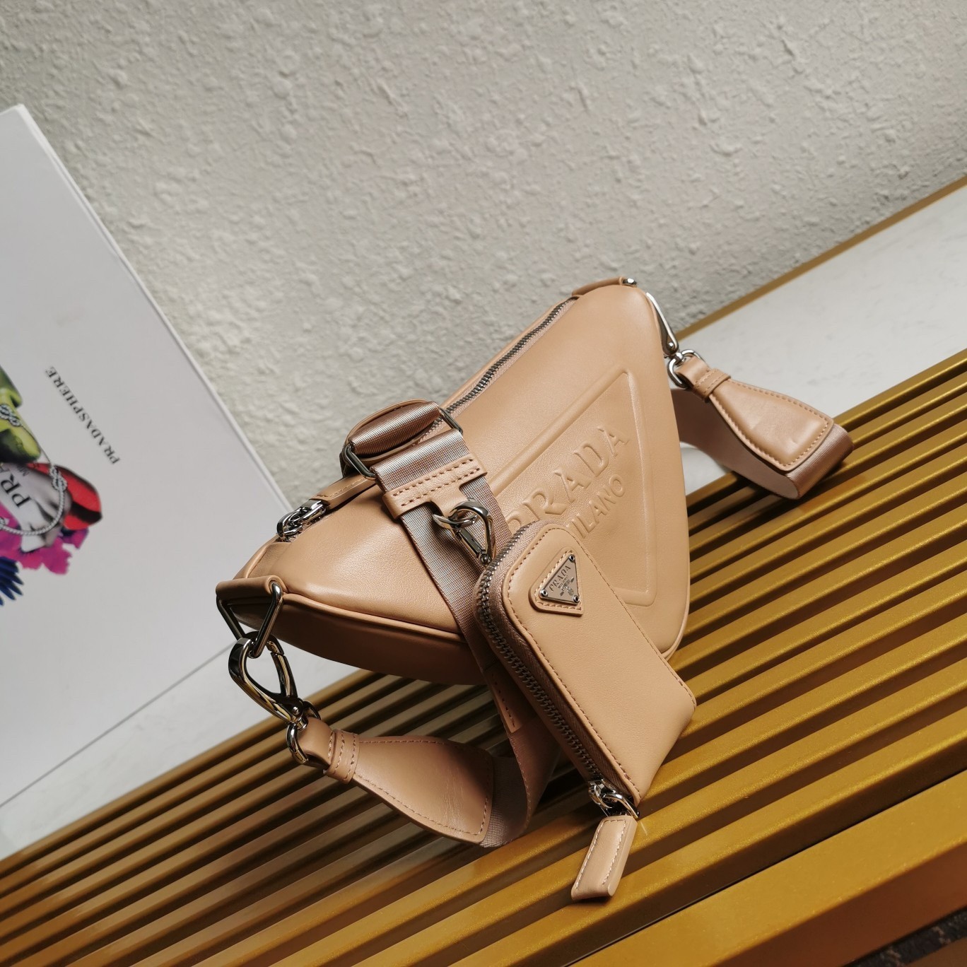 Pra*a triangle shoulder bag in beige leather