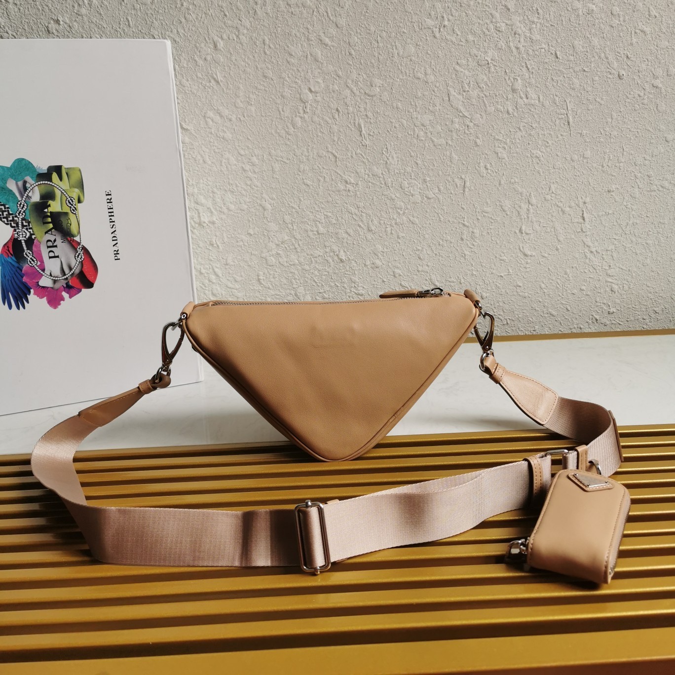 Pra*a triangle shoulder bag in beige leather