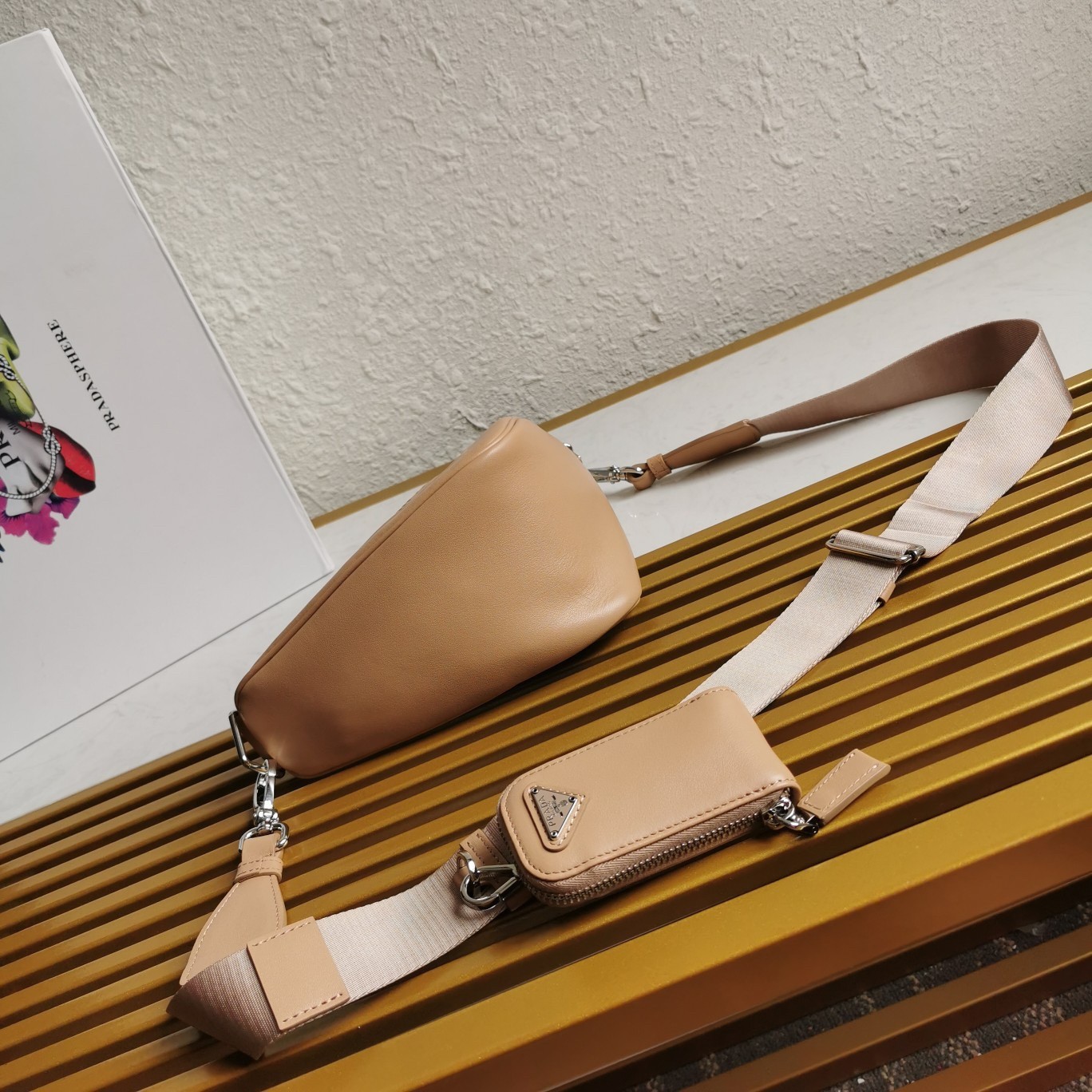 Pra*a triangle shoulder bag in beige leather