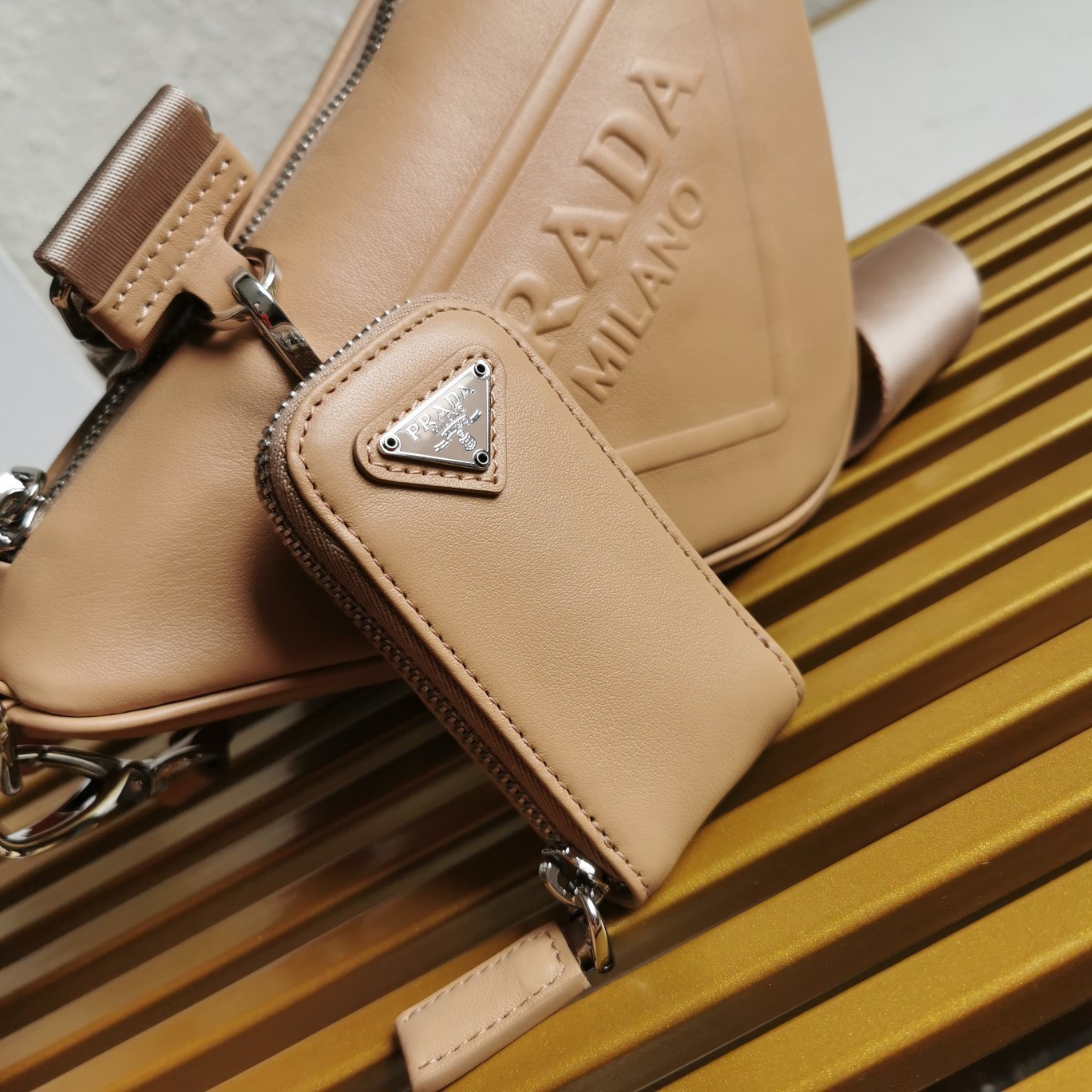 Pra*a triangle shoulder bag in beige leather