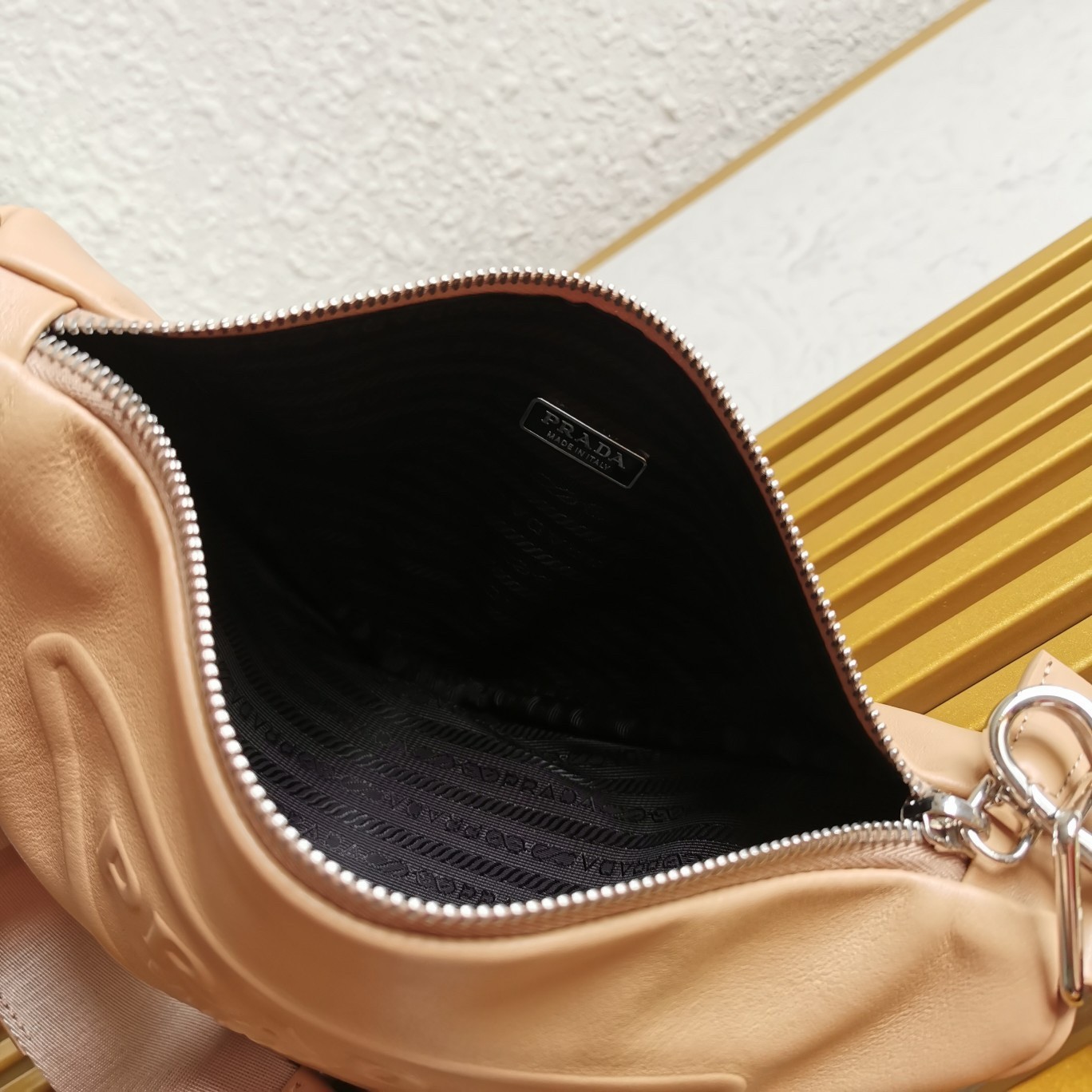 Pra*a triangle shoulder bag in beige leather