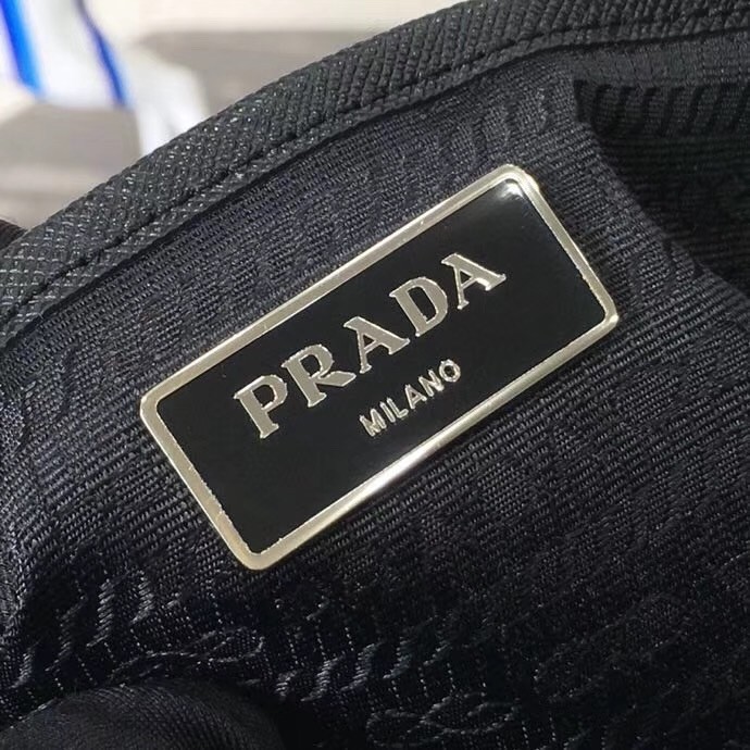 Pra*a black nylon backpack with red metal studs