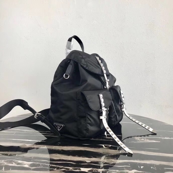 Pra*a black nylon backpack with white metal studs