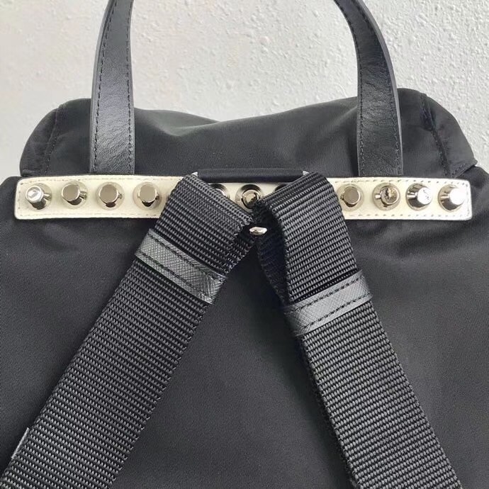 Pra*a black nylon backpack with white metal studs
