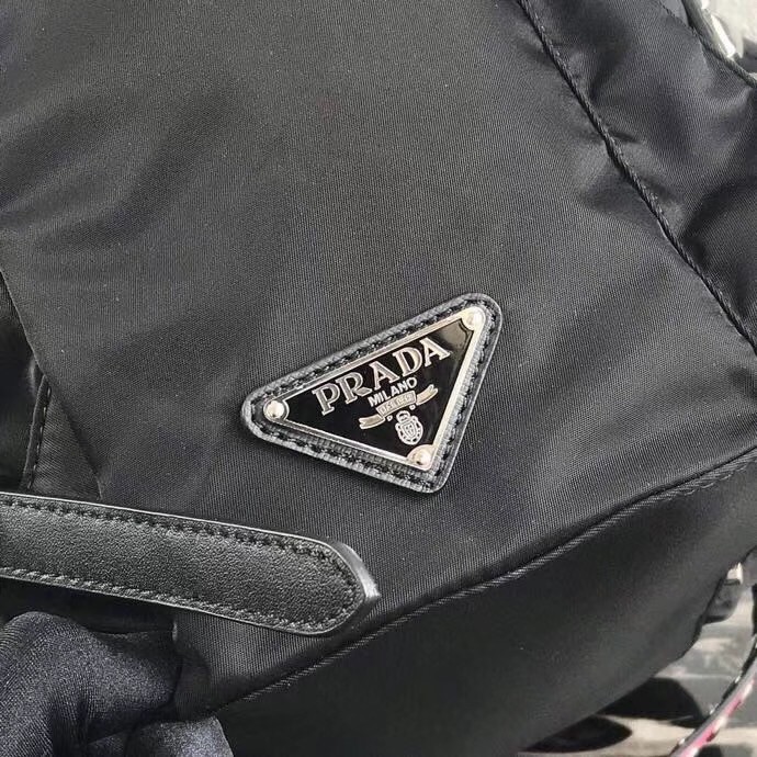 Pra*a black nylon backpack with white metal studs