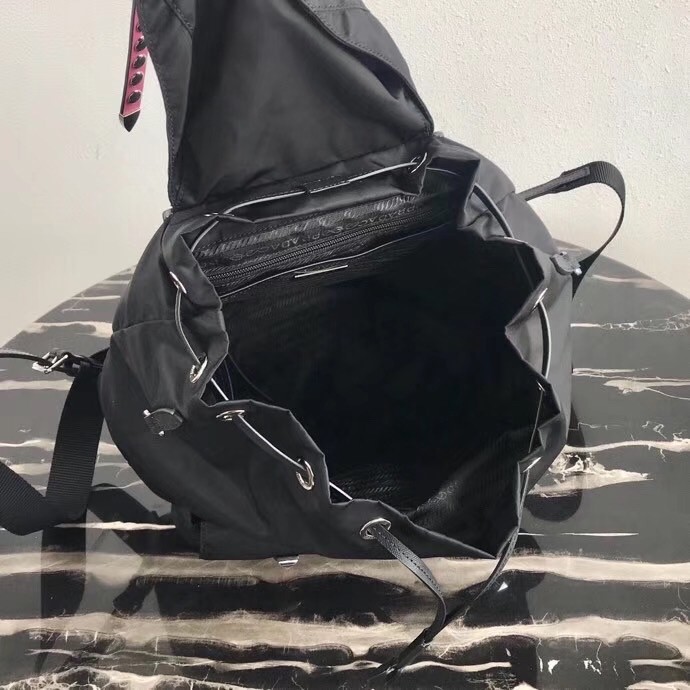 Pra*a black nylon backpack with white metal studs