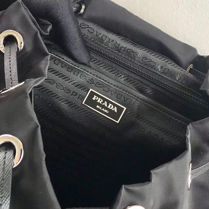 Pra*a black nylon backpack with white metal studs