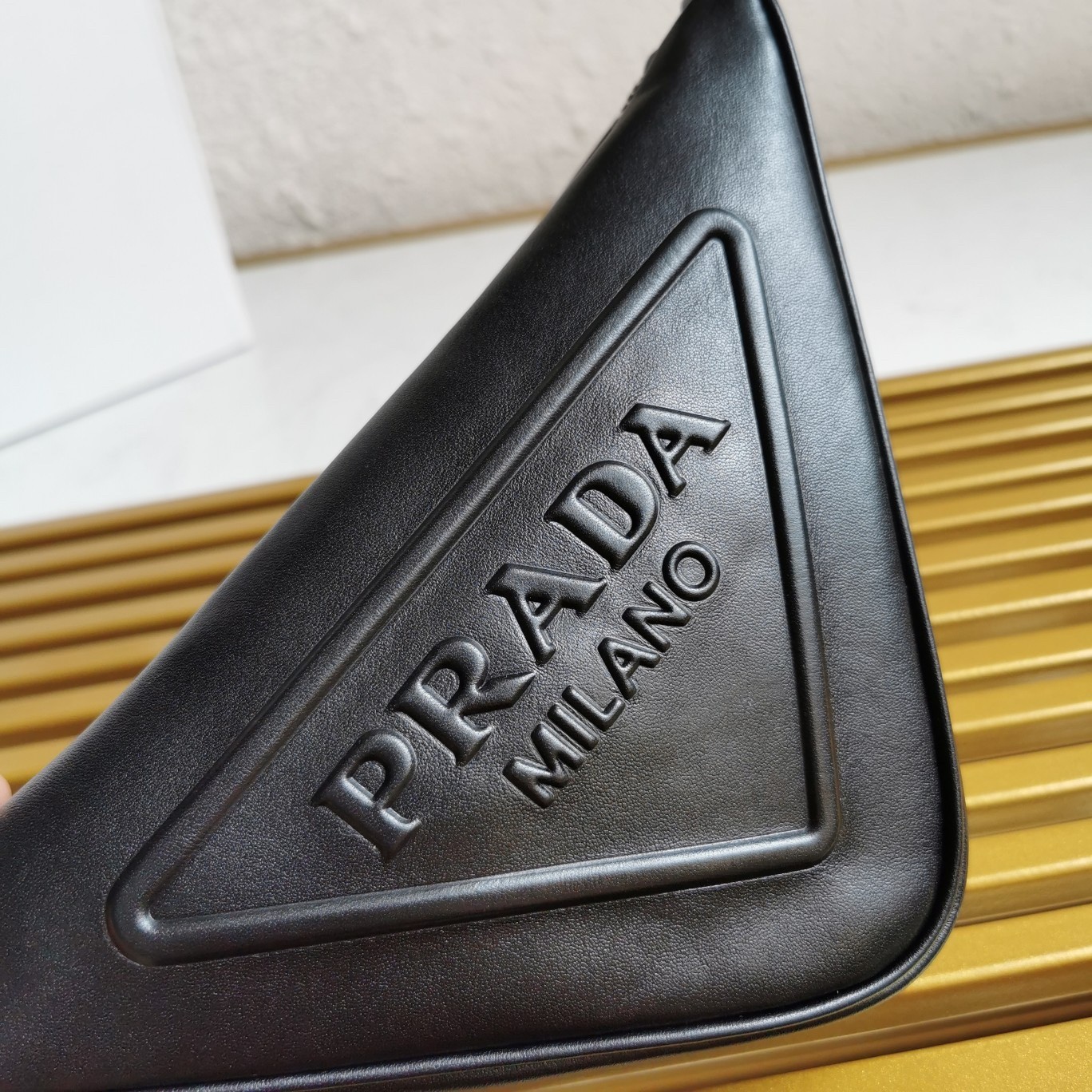 Pra*a triangle pouch bag in black leather
