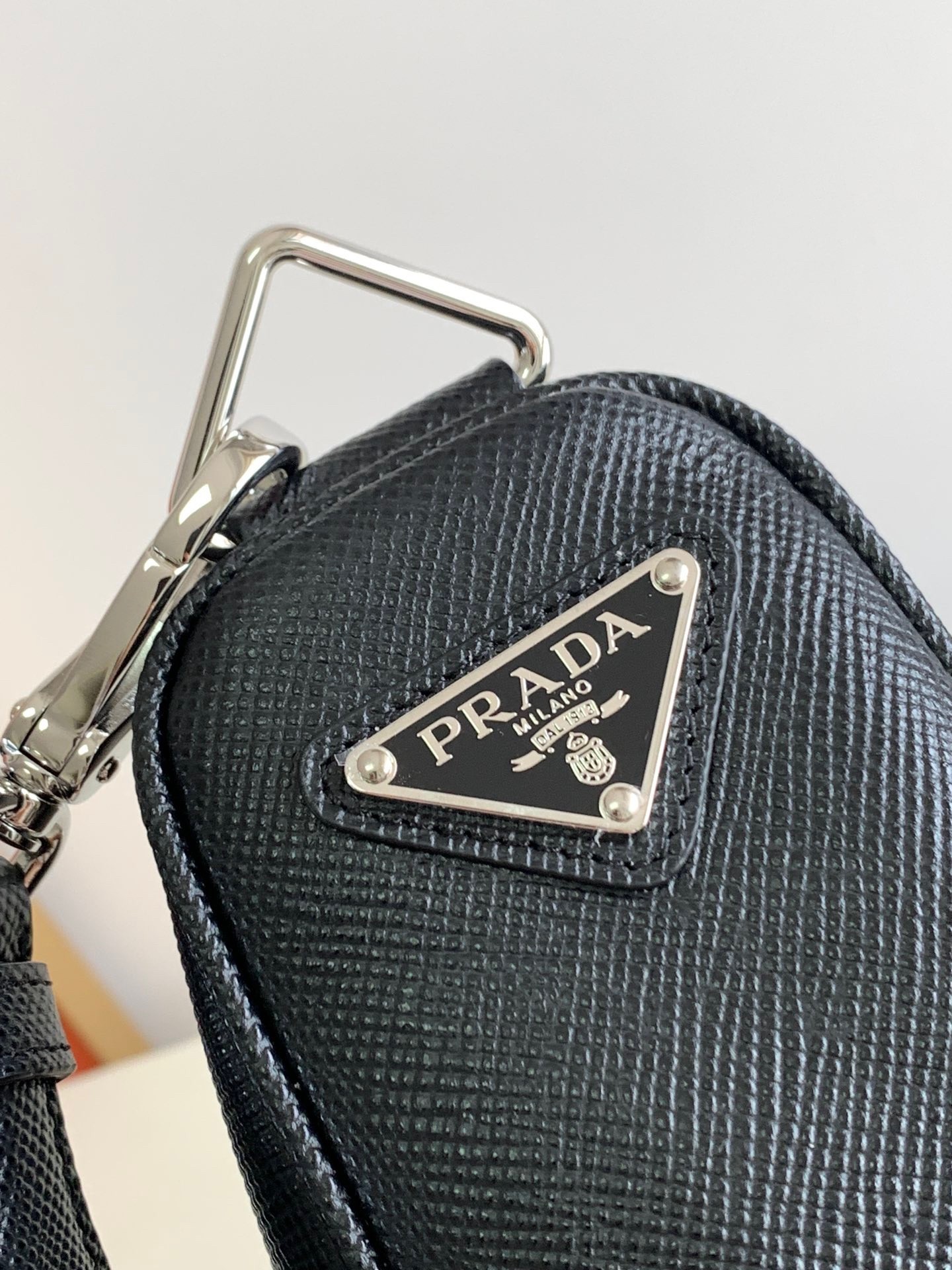 Pra*a triangle shoulder bag in black saffiano calfskin