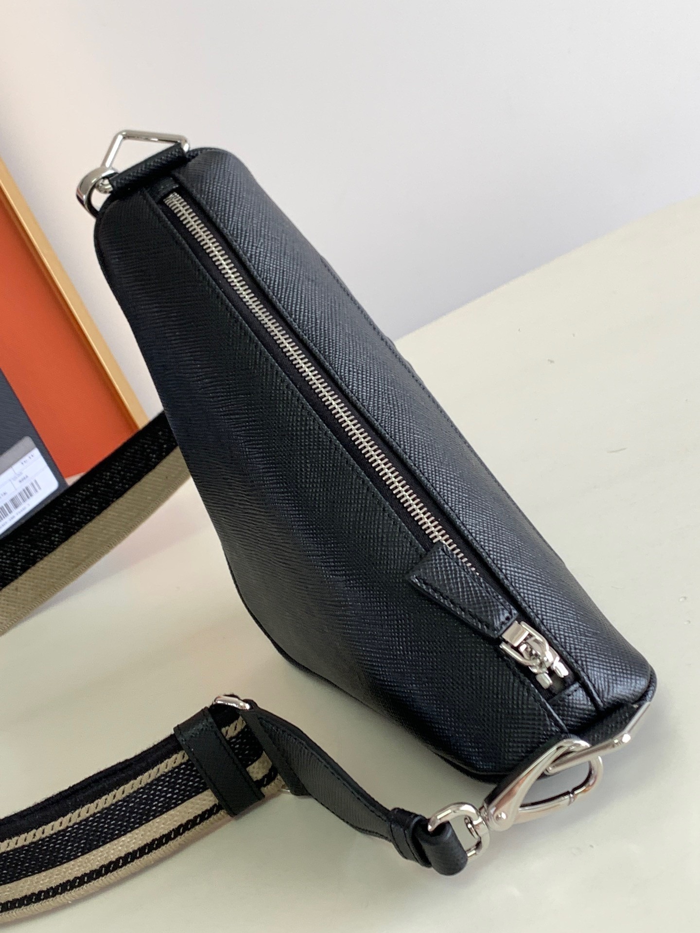 Pra*a triangle shoulder bag in black saffiano calfskin