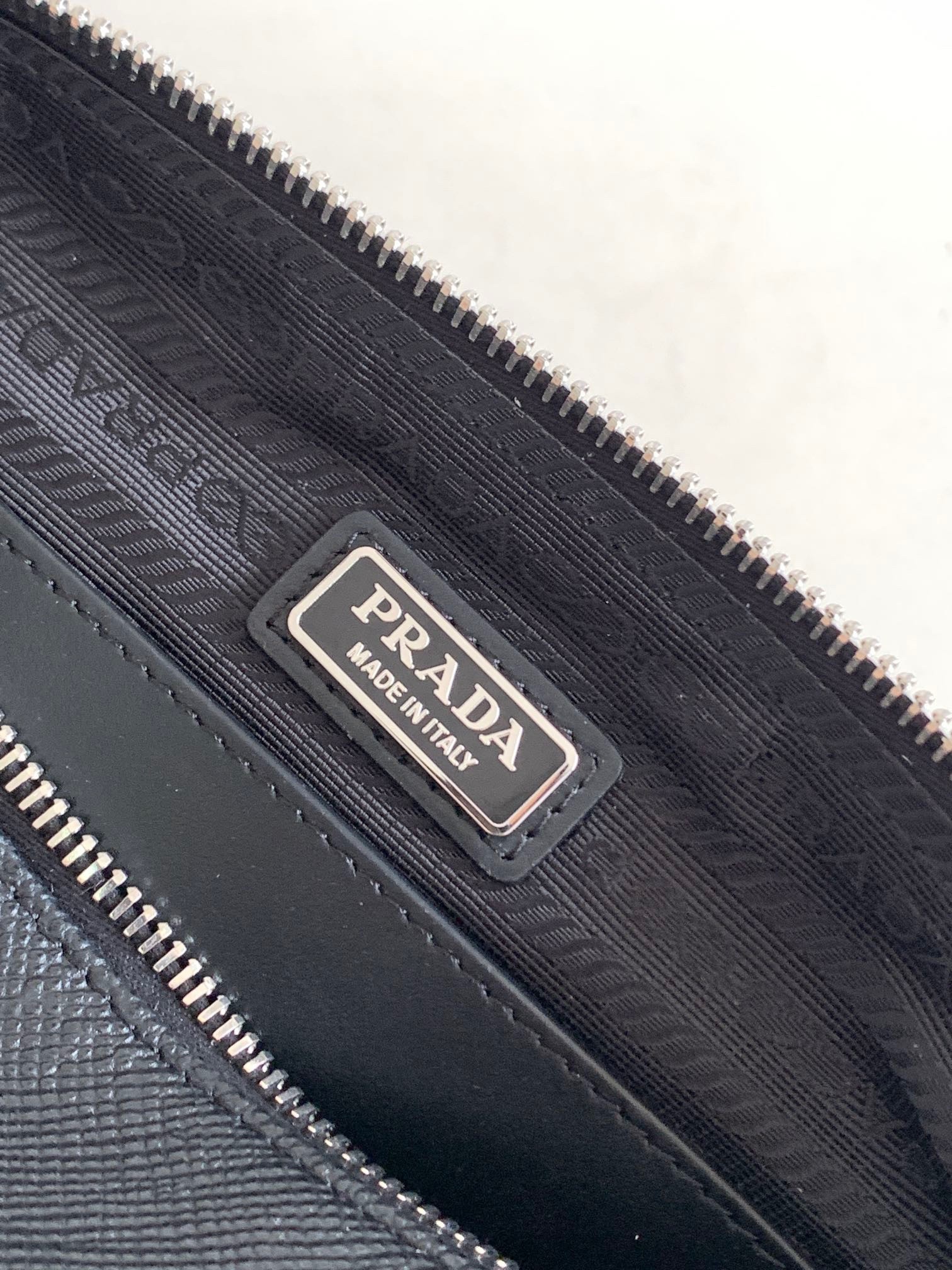 Pra*a triangle shoulder bag in black saffiano calfskin