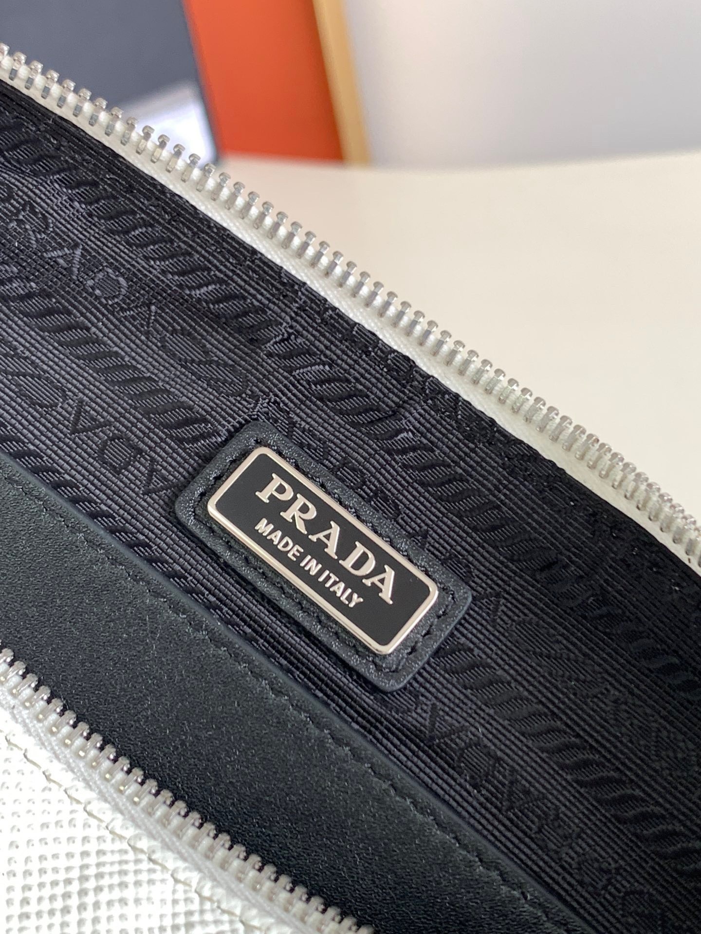 Pra*a triangle shoulder bag in white saffiano calfskin