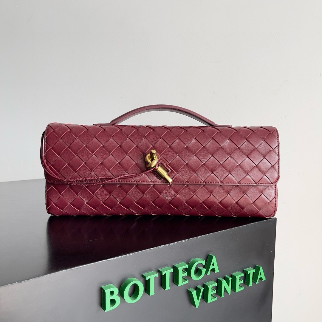 bo*te*ga Ve*ne*ta andiamo clutch with handle in barolo intrecciato lambskin