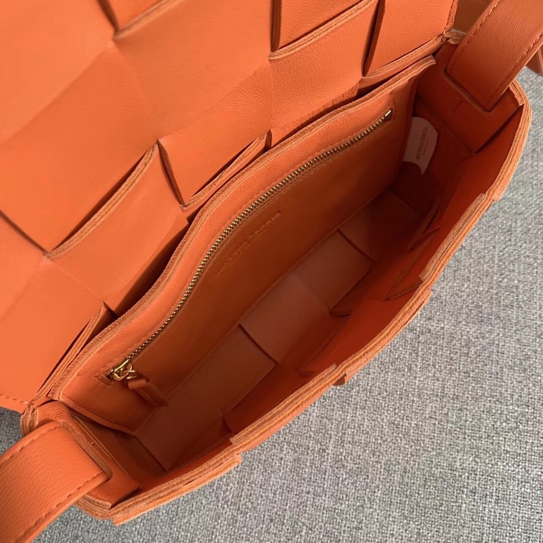 bo*te*ga Ve*ne*ta cassette bag in orange lambskin
