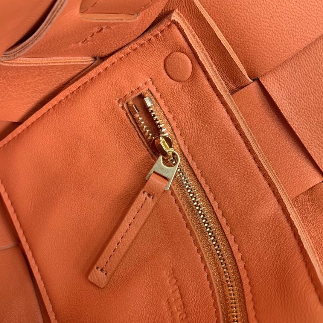 bo*te*ga Ve*ne*ta cassette bag in orange lambskin