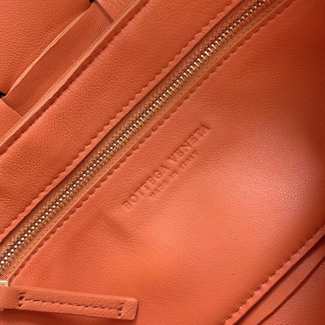 bo*te*ga Ve*ne*ta cassette bag in orange lambskin