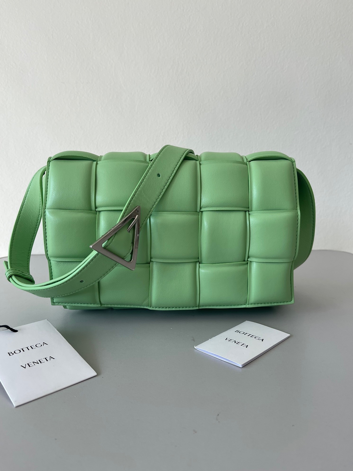 bo*te*ga Ve*ne*ta padded cassette bag in acid green lambskin