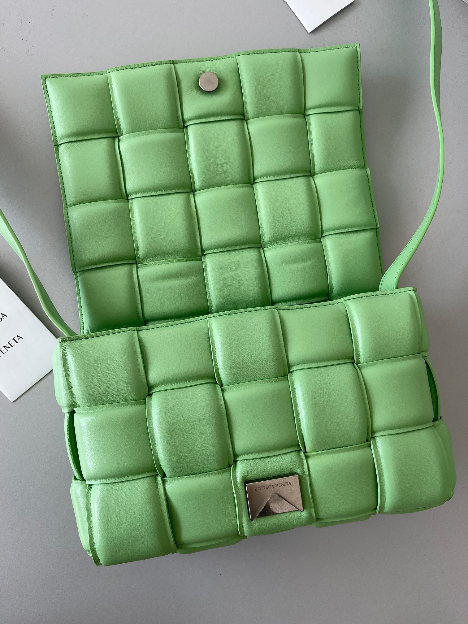 bo*te*ga Ve*ne*ta padded cassette bag in acid green lambskin