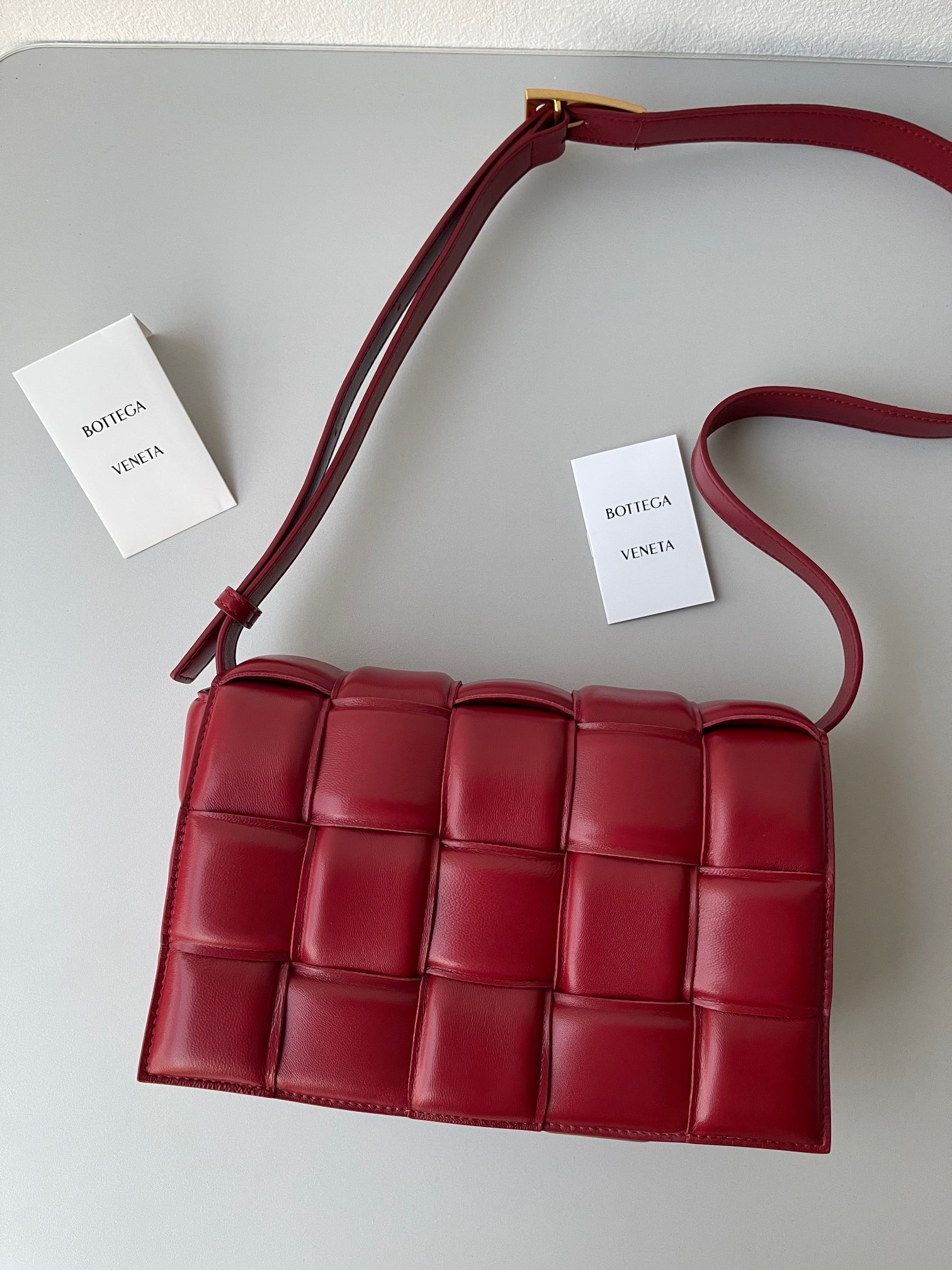 bo*te*ga Ve*ne*ta padded cassette bag in dard red lambskin