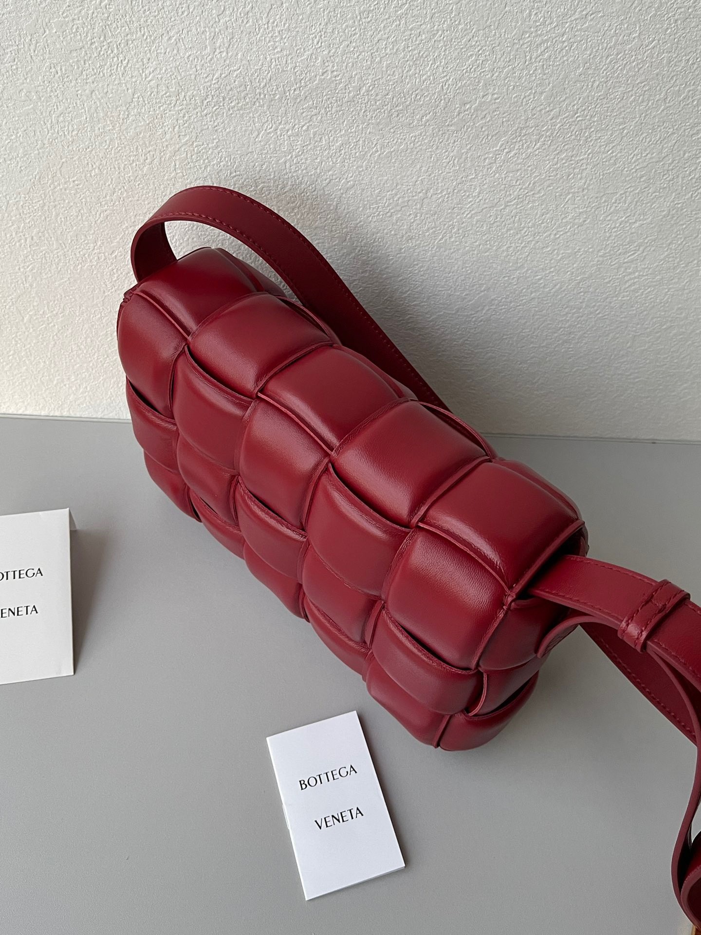 bo*te*ga Ve*ne*ta padded cassette bag in dard red lambskin