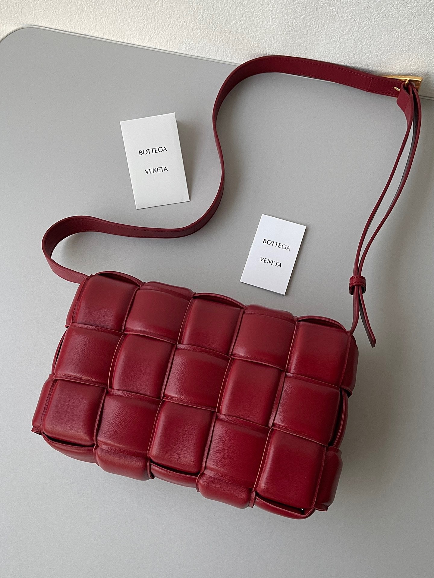 bo*te*ga Ve*ne*ta padded cassette bag in dard red lambskin