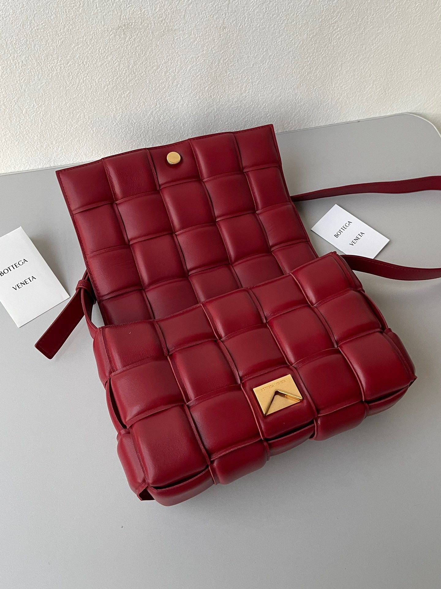 bo*te*ga Ve*ne*ta padded cassette bag in dard red lambskin