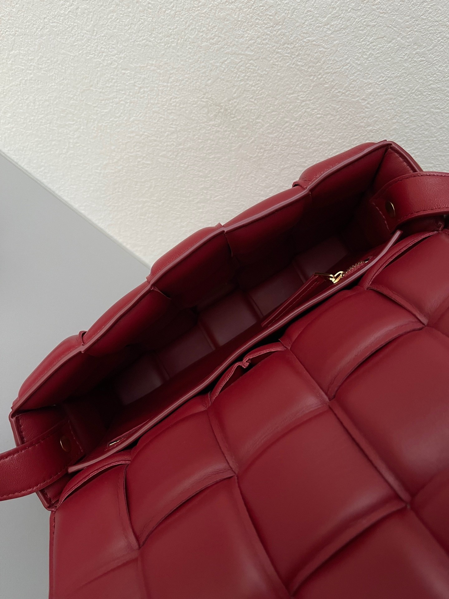 bo*te*ga Ve*ne*ta padded cassette bag in dard red lambskin