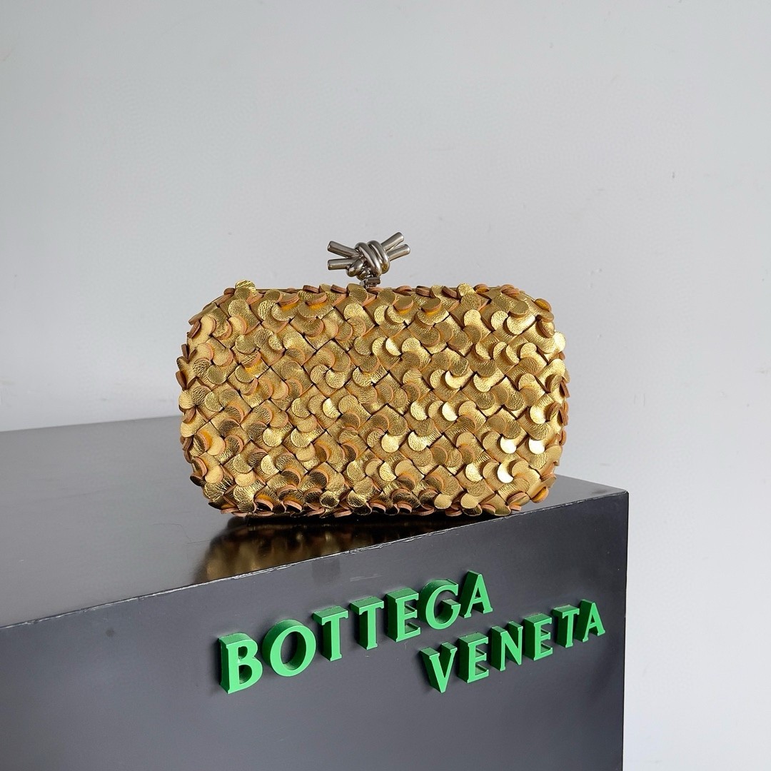 bo*te*ga Ve*ne*ta knot minaudiere clutch in gold sequins laminated leather