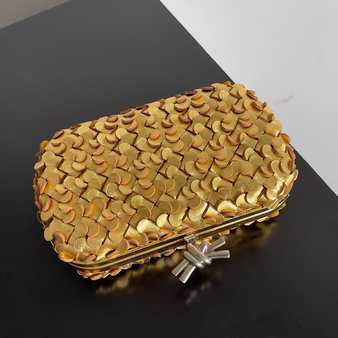 bo*te*ga Ve*ne*ta knot minaudiere clutch in gold sequins laminated leather