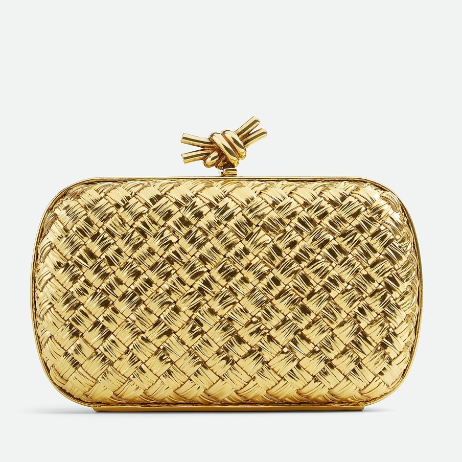 bo*te*ga Ve*ne*ta knot minaudiere clutch in gold intreccio laminated leather