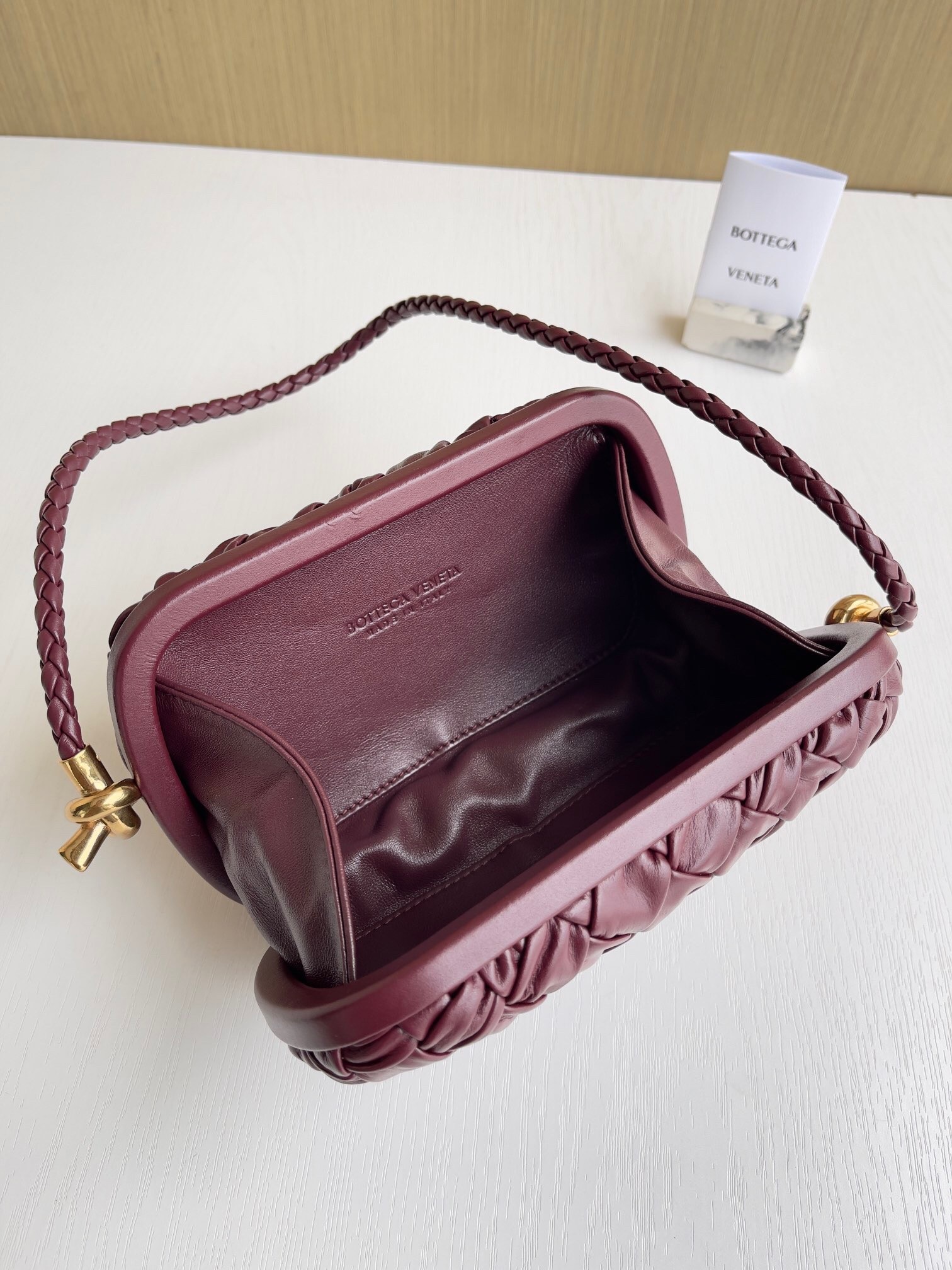 bo*te*ga Ve*ne*ta knot minaudiere on strap in barolo foulard intreccio leather