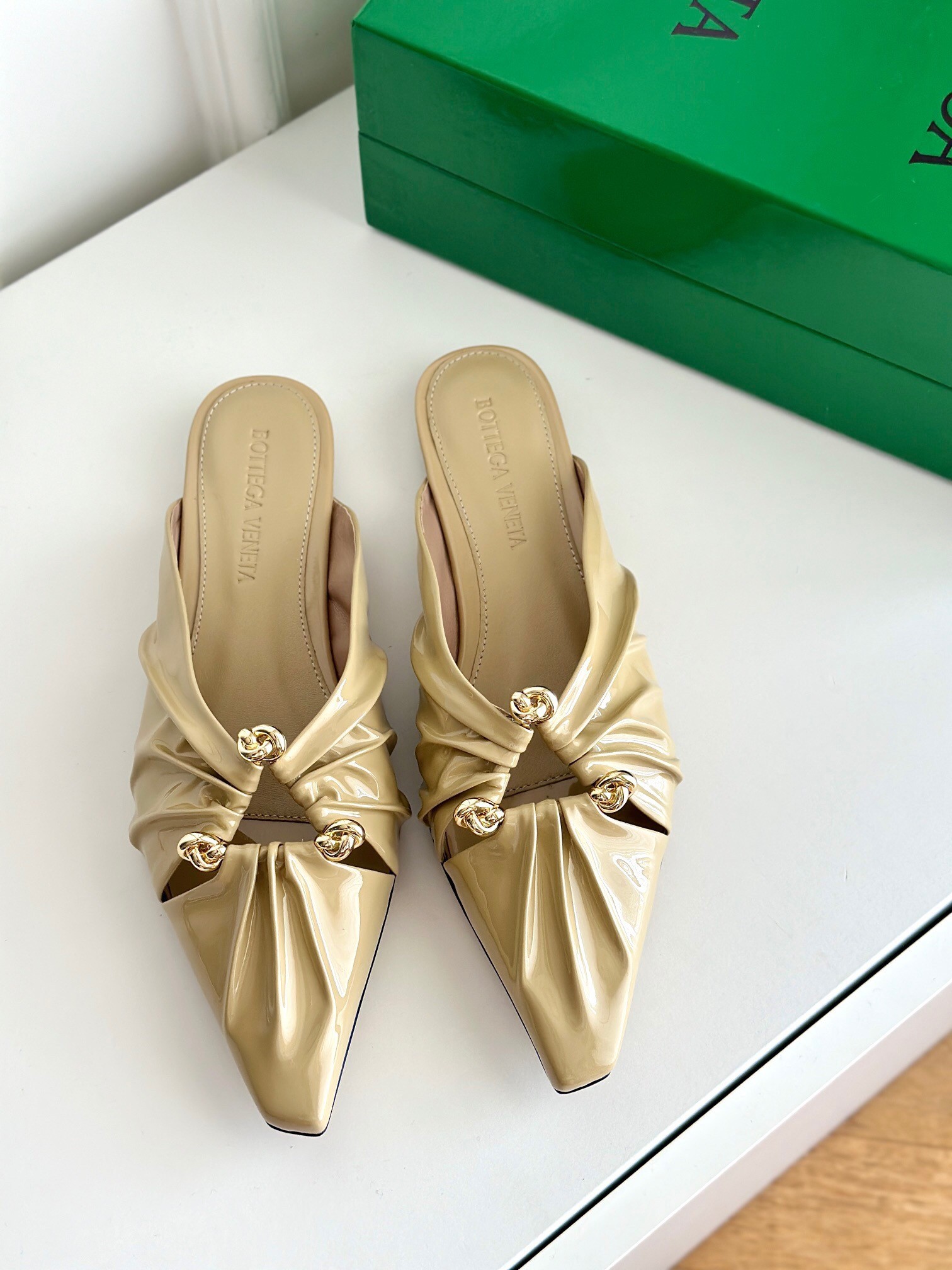 bo*te*ga Ve*ne*ta bunnie flat mules in beige patent leather