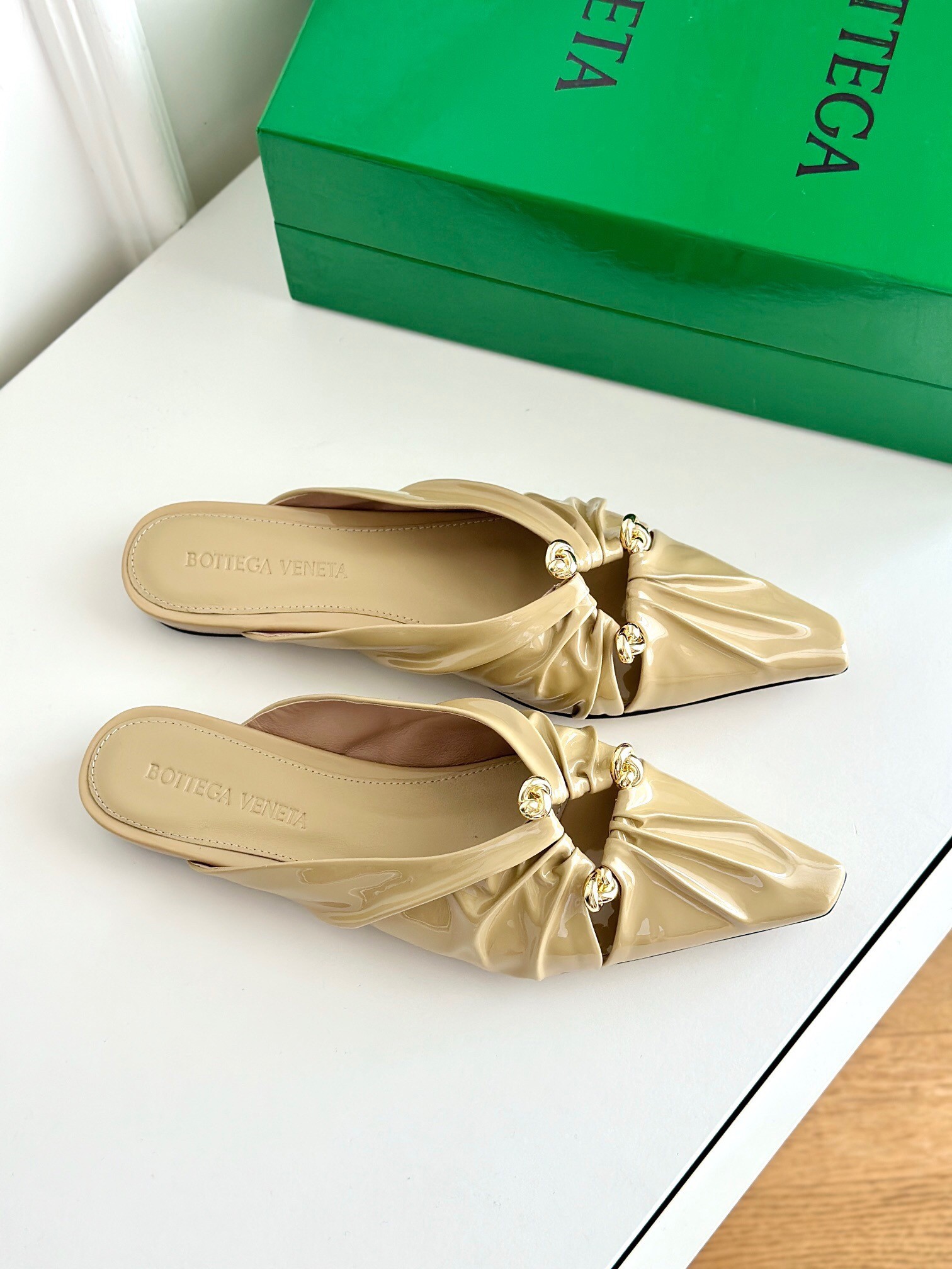 bo*te*ga Ve*ne*ta bunnie flat mules in beige patent leather