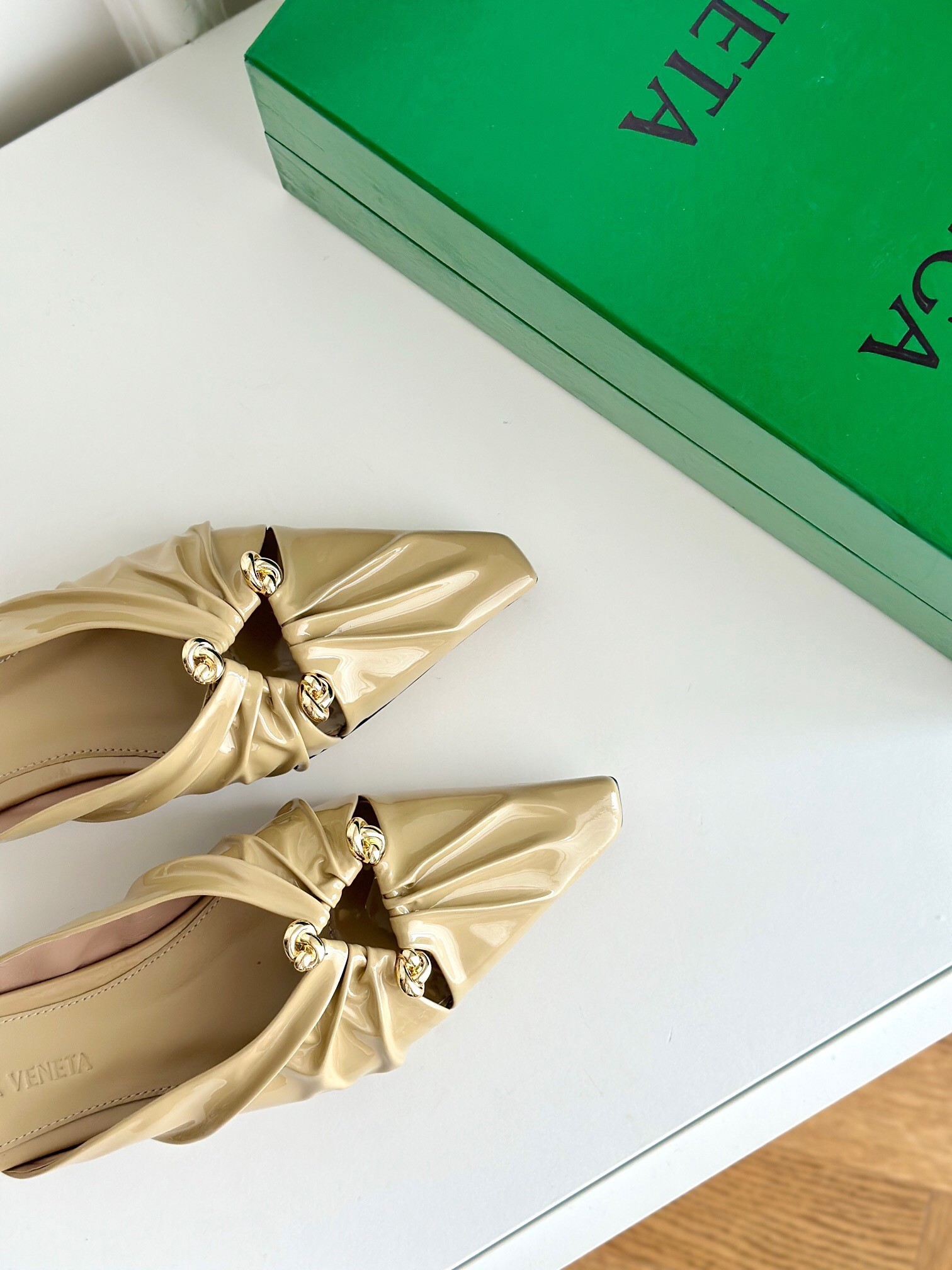 bo*te*ga Ve*ne*ta bunnie flat mules in beige patent leather