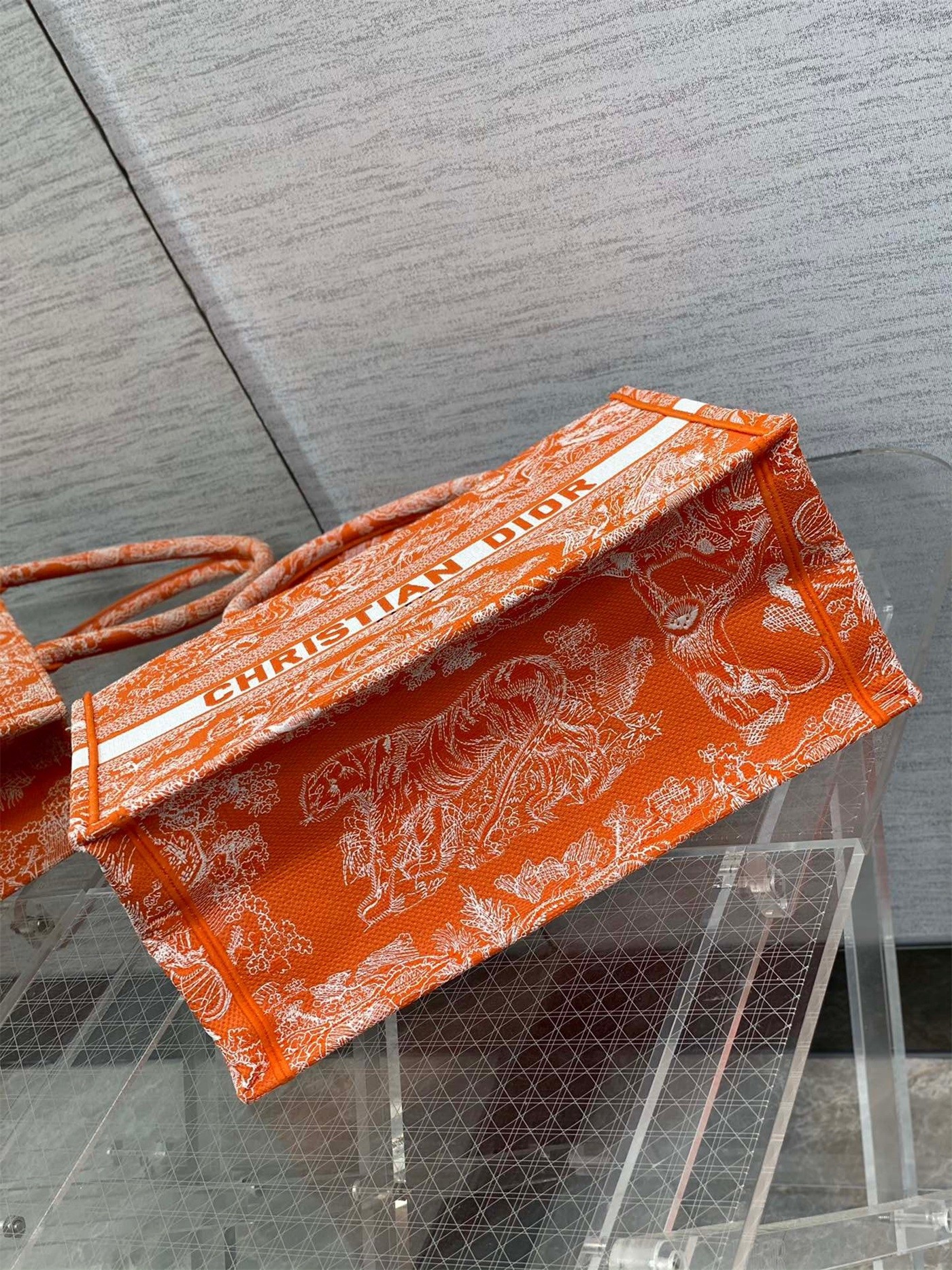D*or medium book tote bag in fluorescent orange toile de jouy reverse embroidery