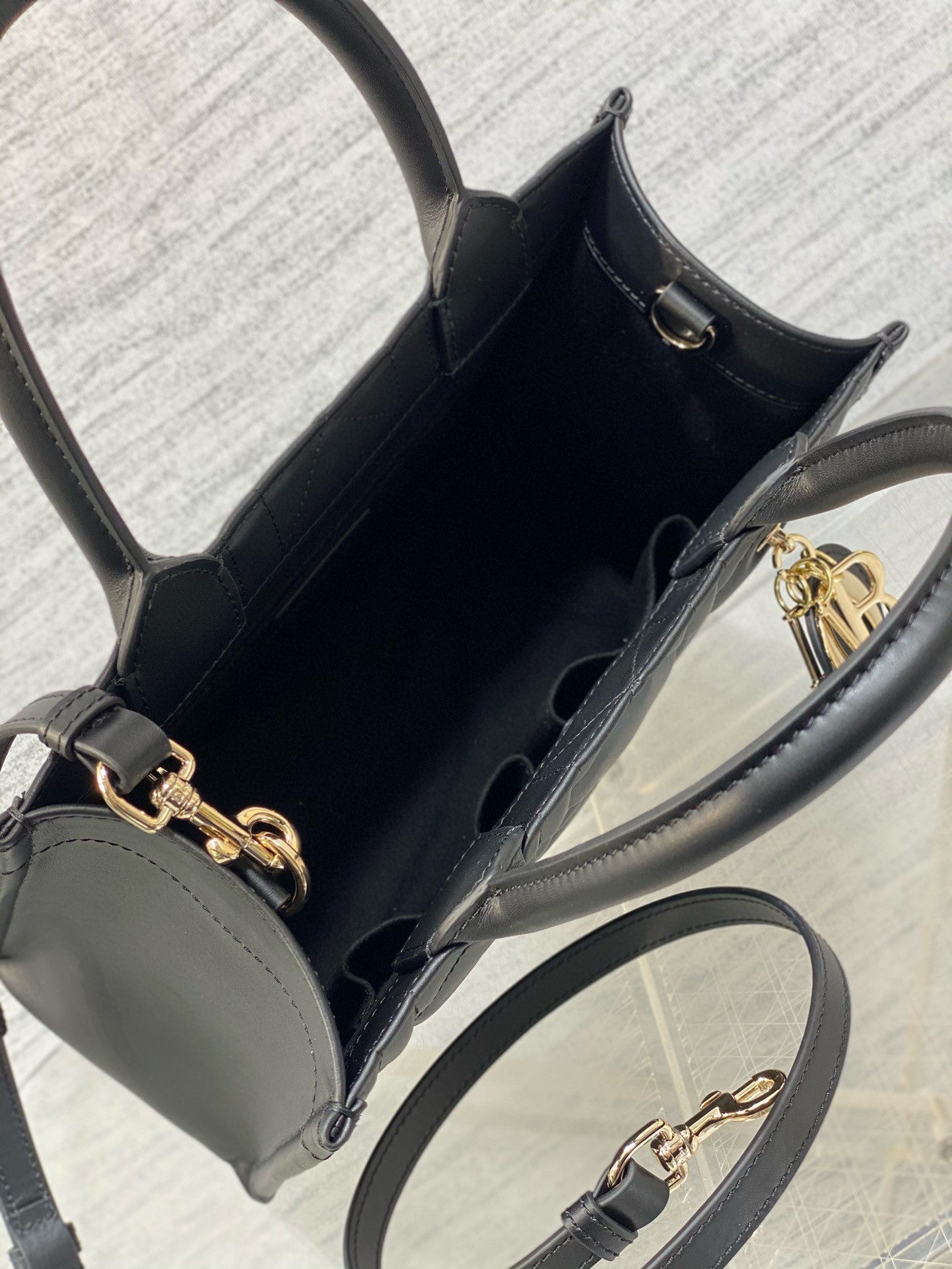 D*or small book tote bag with strap in black macrocannage calfskin