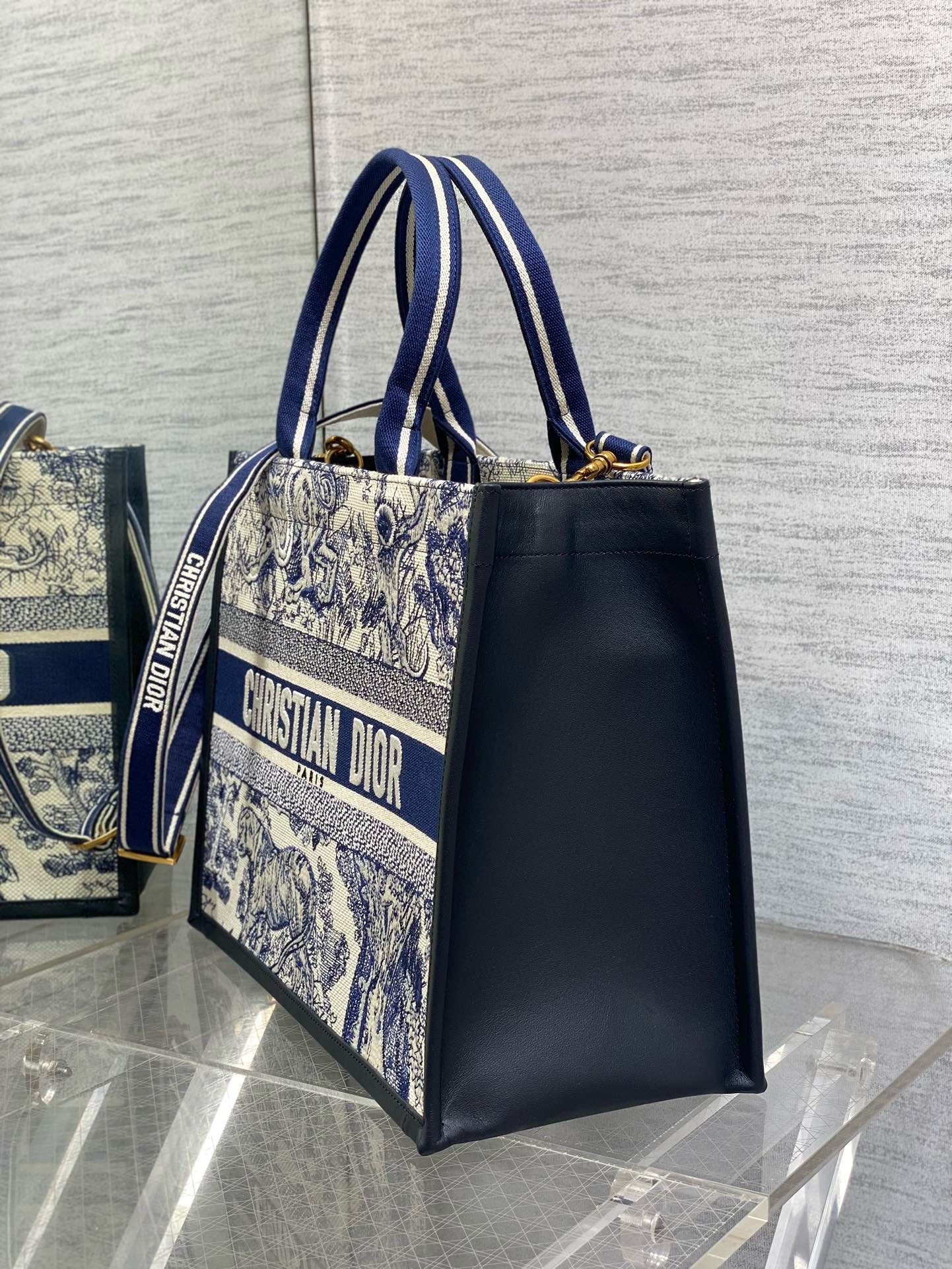 D*or medium book tote bag with strap in blue toile de jouy sauvage embroidery