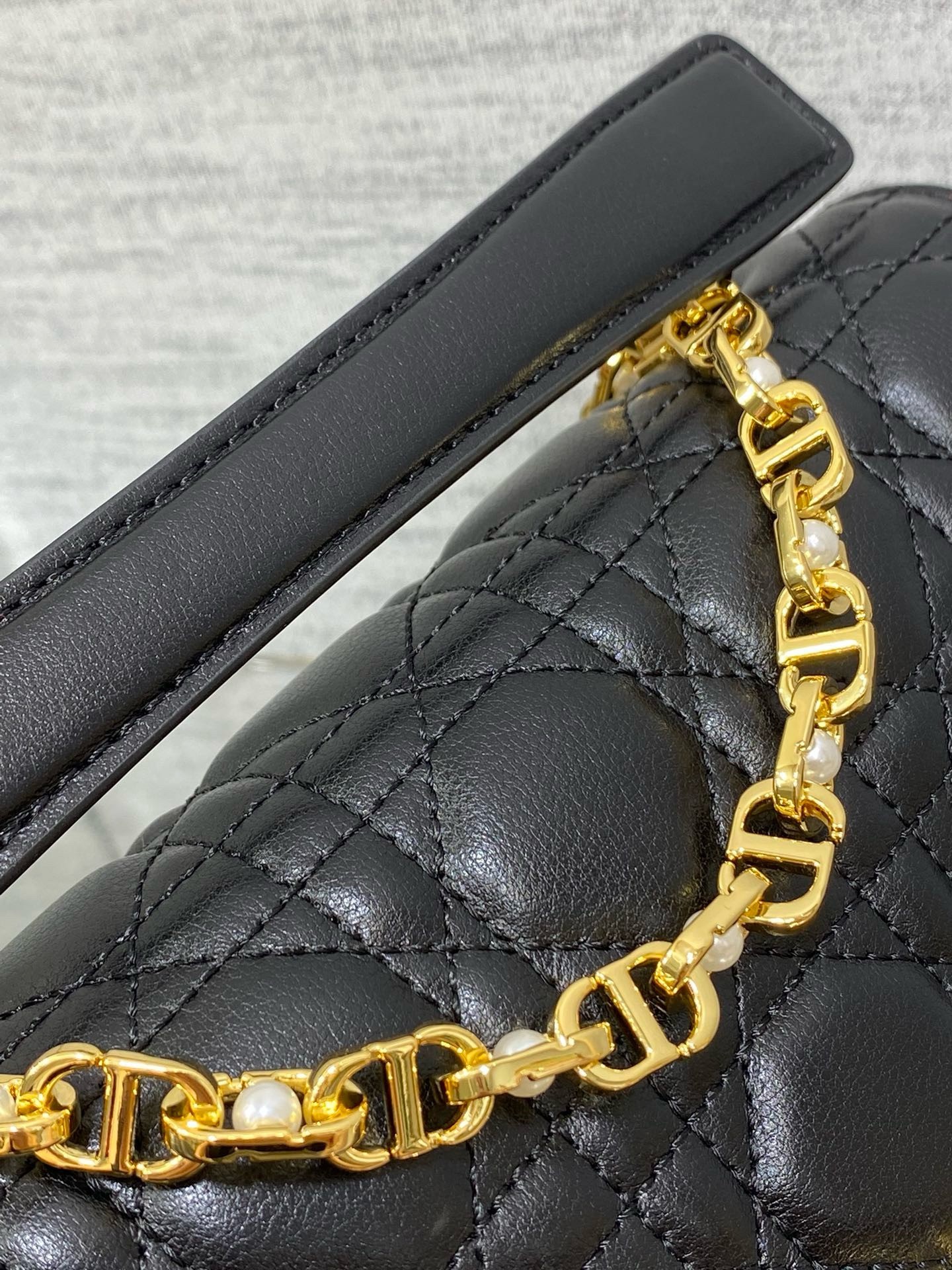 D*or small jolie top handle bag in black cannage calfskin